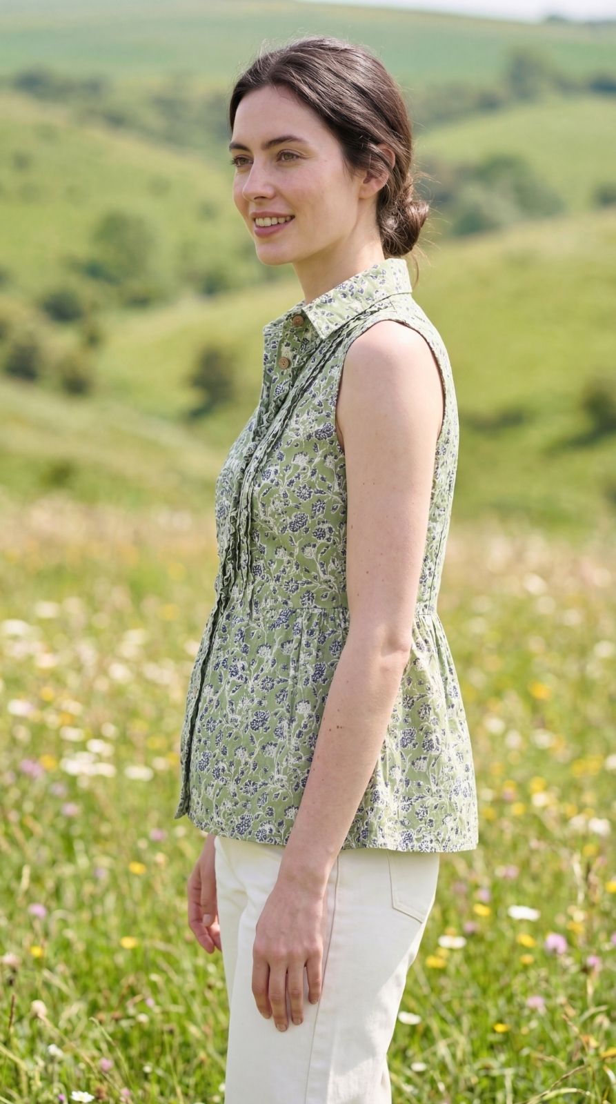 Side view styled view of Sunavyaa green floral cotton top with shirt collar and wooden buttons