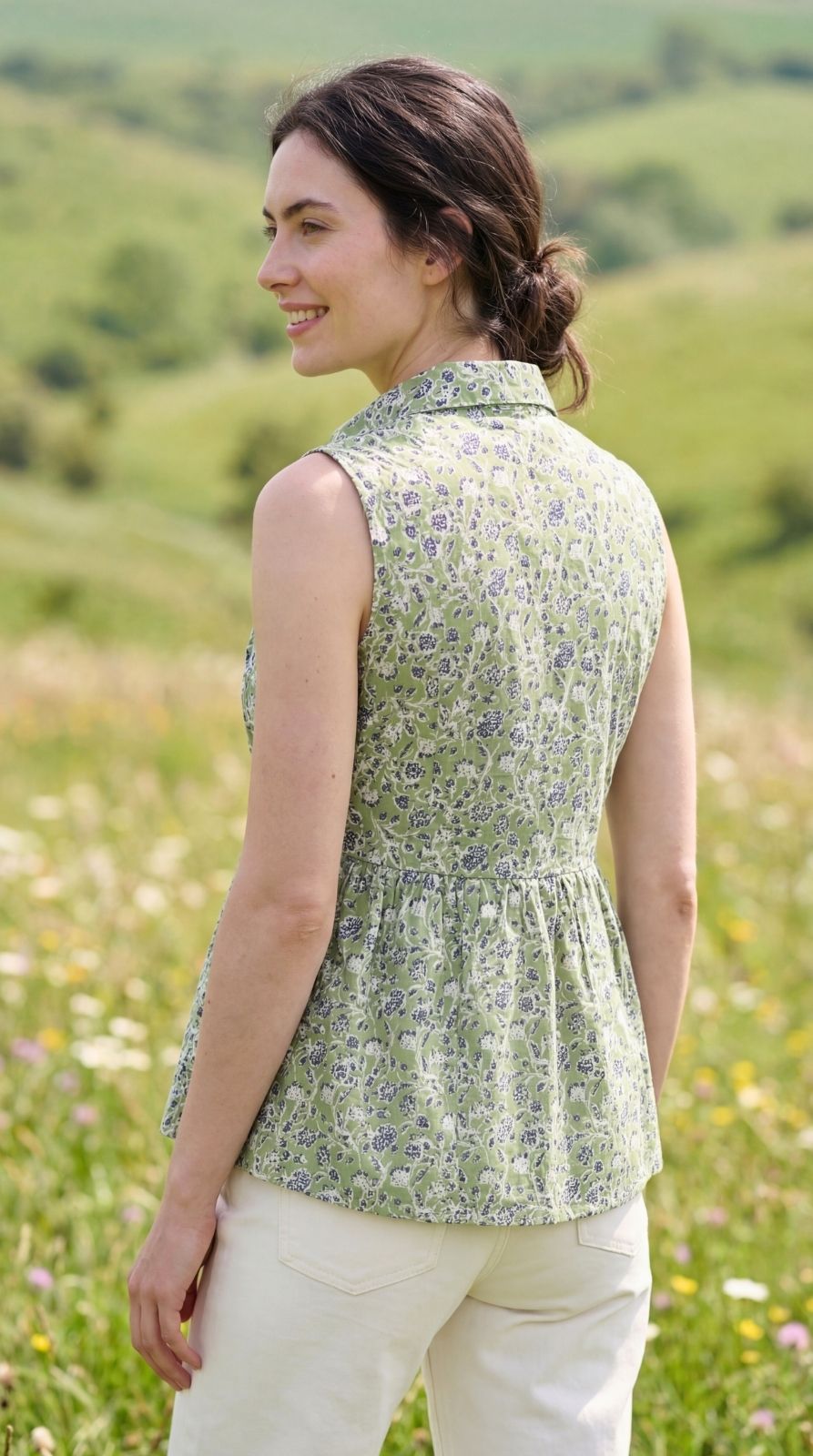 Close up detail of wooden buttons and shirt collar on Sunavyaa green floral print princess cut top