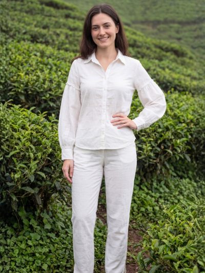 Full length styled view of Sunavyaa white crush cotton co-ord set with puff sleeves and narrow pants