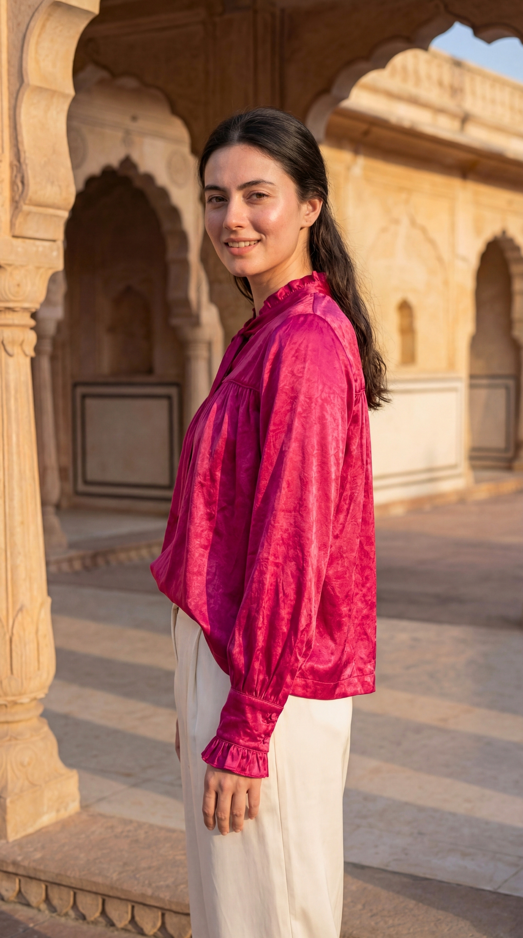 Side view of Sunavyaa deep pink gajji silk top showing loose fit silhouette and bow belt tie detail