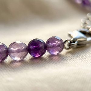 Macro close-up of amethyst crystal beads on Sunavyaa anklet showing violet translucence