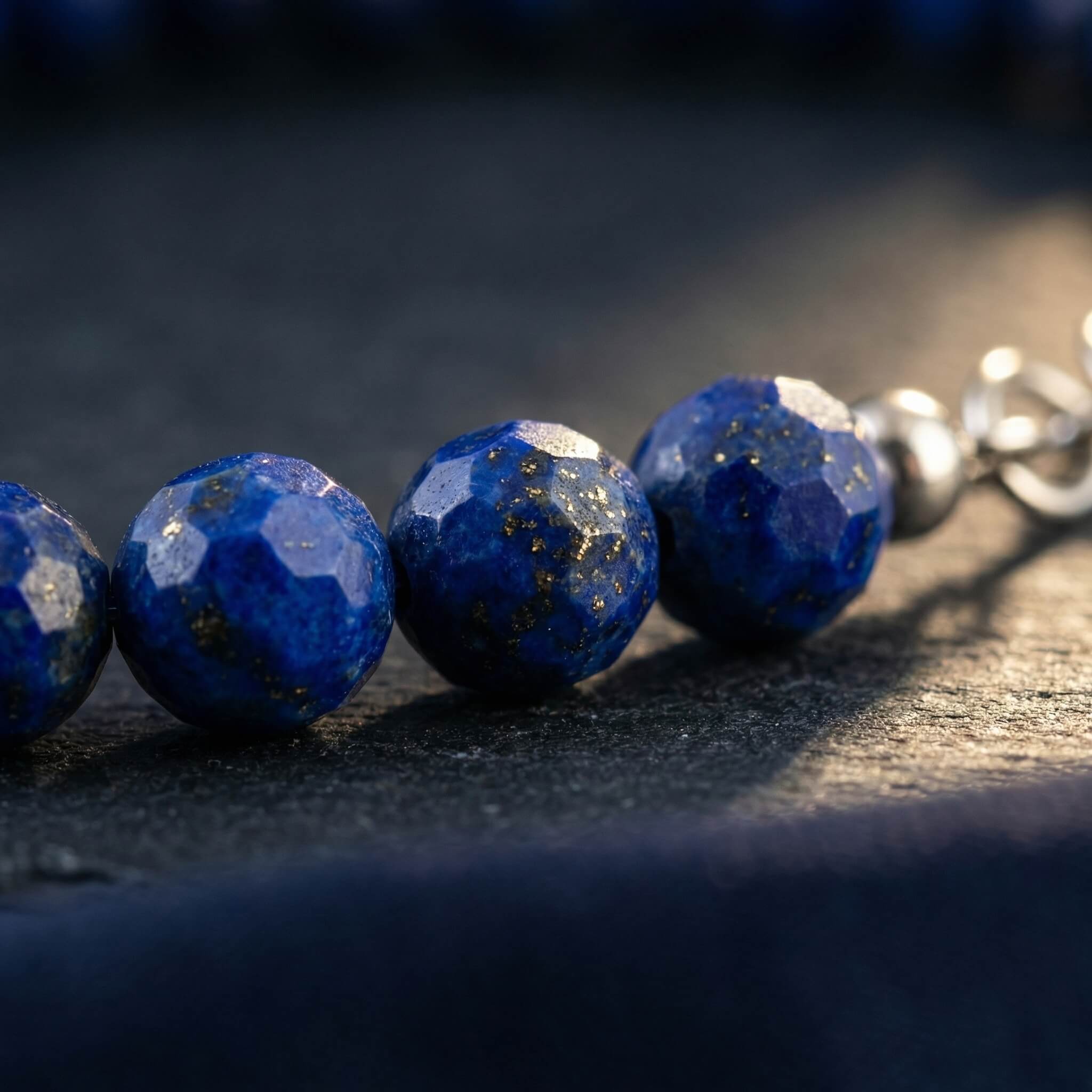 Macro close-up of lapis lazuli beads on Sunavyaa anklet showing deep blue colour and gold pyrite flecks