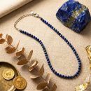 Sunavyaa lapis lazuli crystal anklet on dark navy marble with raw lapis stone and blue thistle