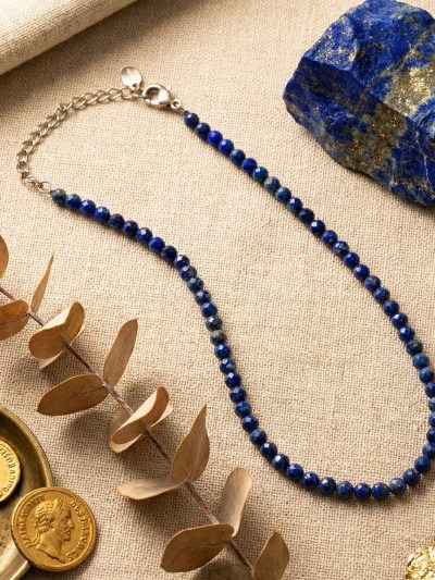 Sunavyaa lapis lazuli crystal anklet on dark navy marble with raw lapis stone and blue thistle