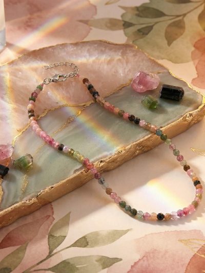 Sunavyaa multi tourmaline crystal anklet flat lay on white surface with mixed crystal chips in pink green blue yellow